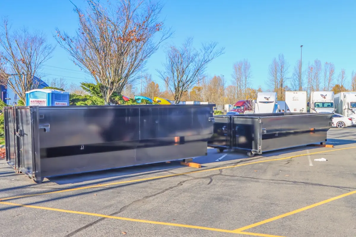 Professional dumpster rental service with roll-off container on residential driveway in Solebury